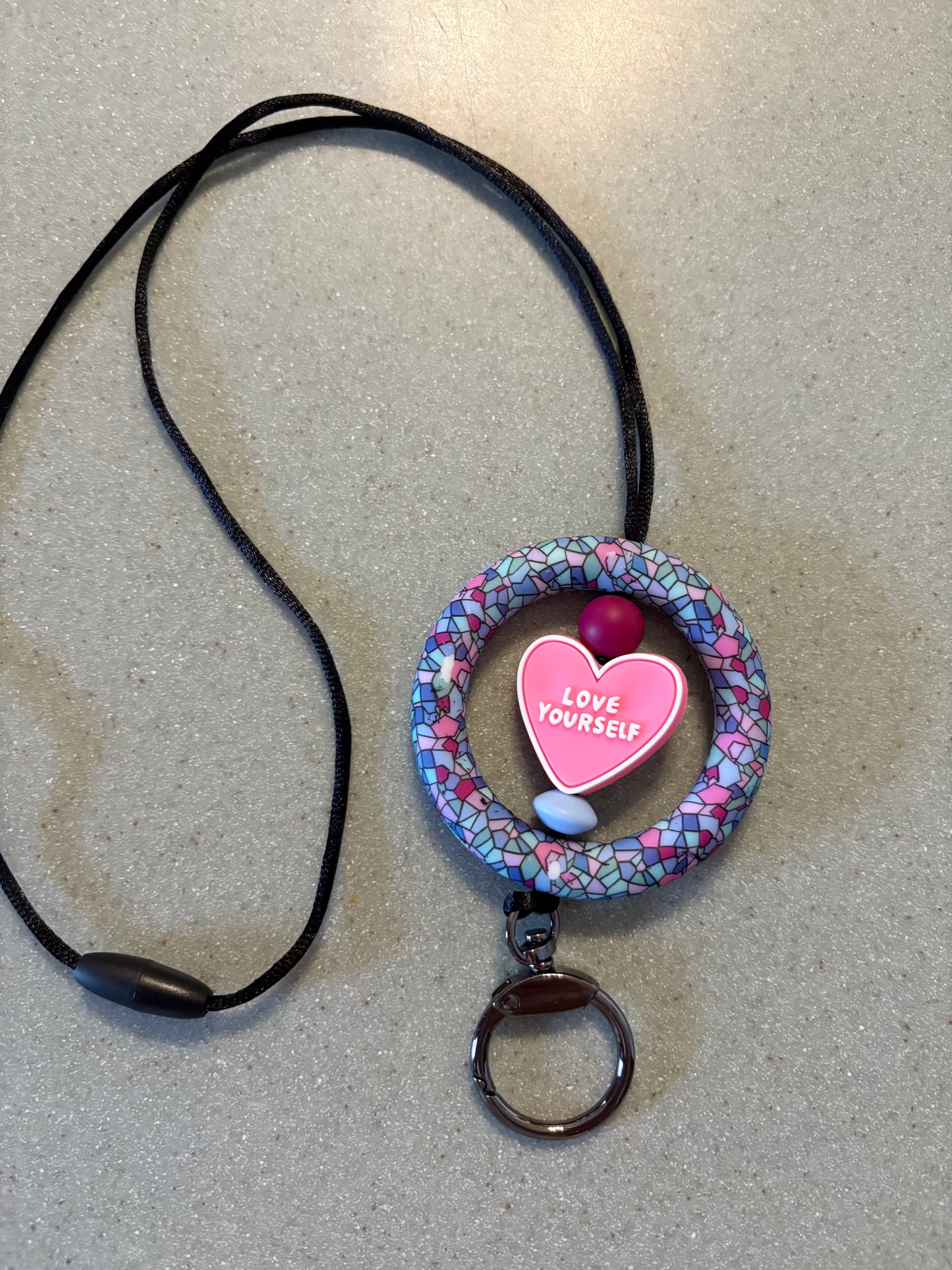 2.5” stained glass designed silicone ring with pink love yourself focal bead