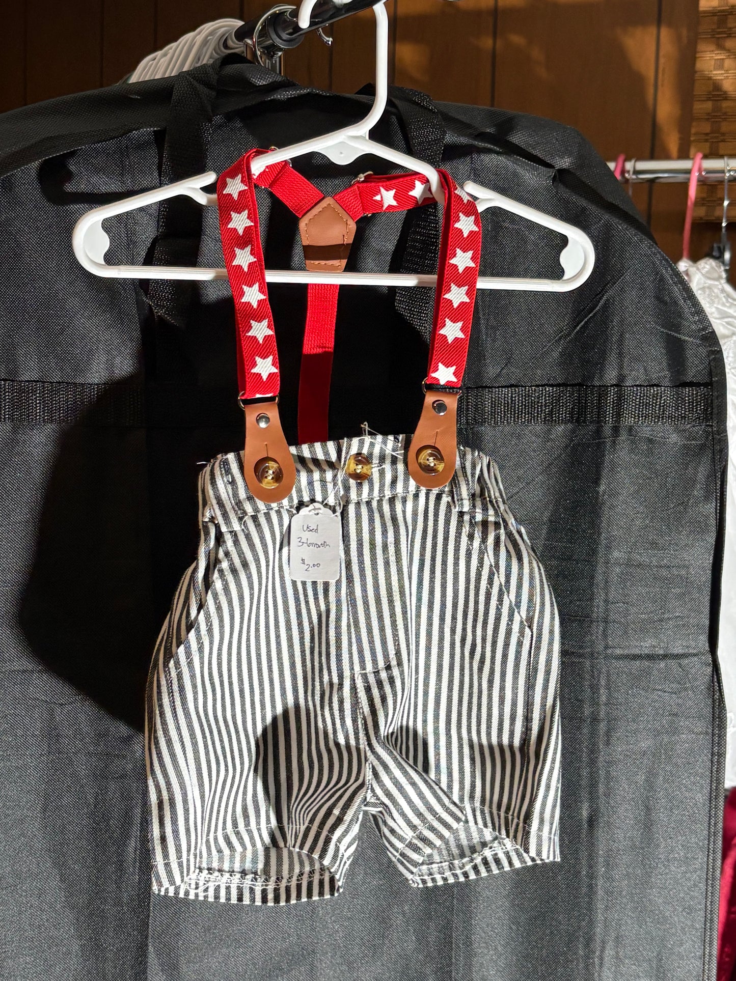 Size 3-6 month, black and white striped shorts with suspenders.