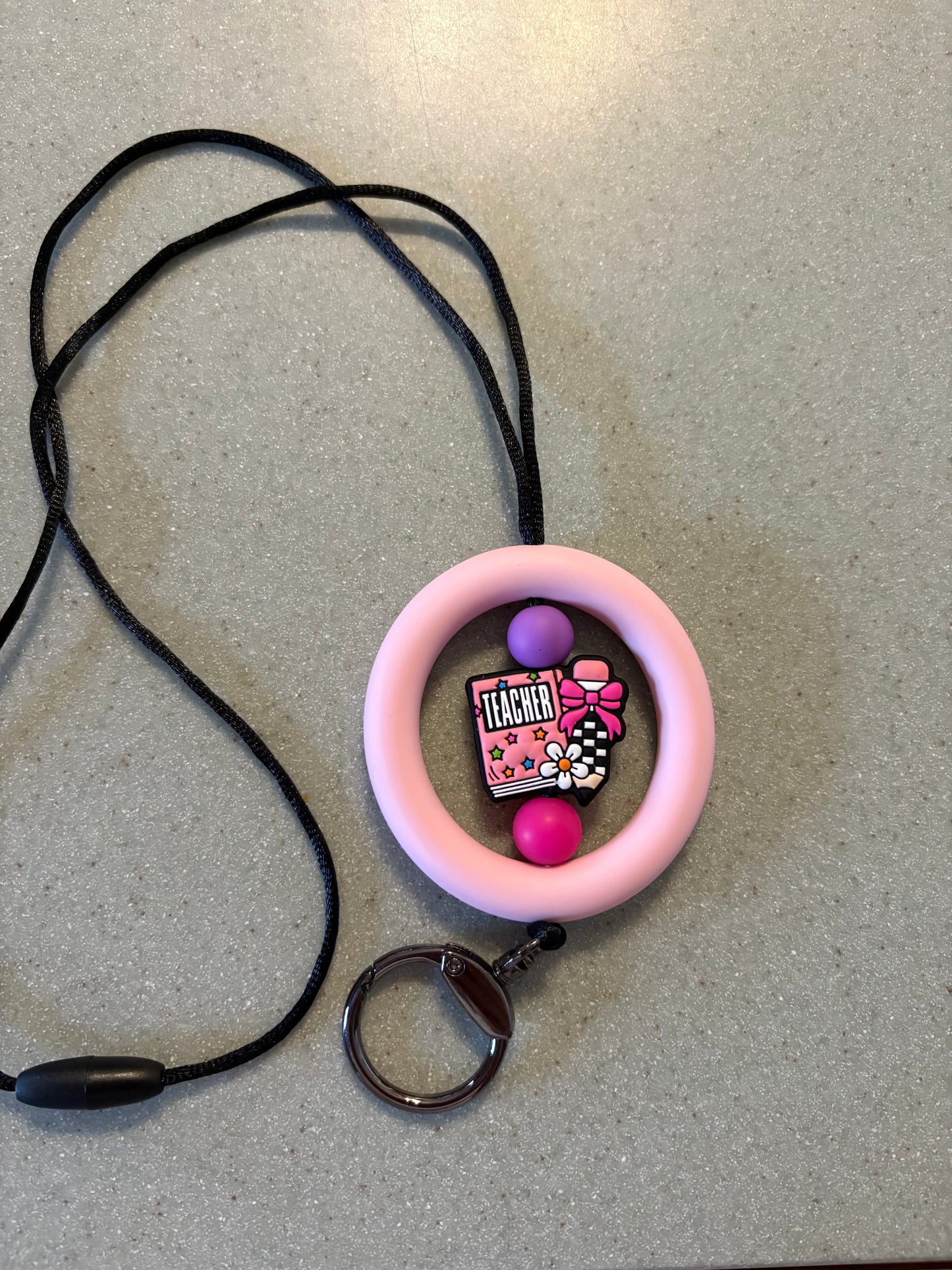 2.5” light, pink silicone ring with teacher focal bead
