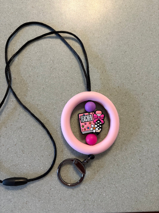 2.5” light, pink silicone ring with teacher focal bead