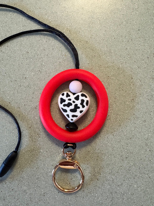 2.5” red silicone ring with black and white cow print heart￼