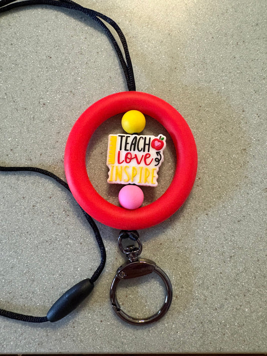 2.5” red silicone ring with teach love, inspire focal bead