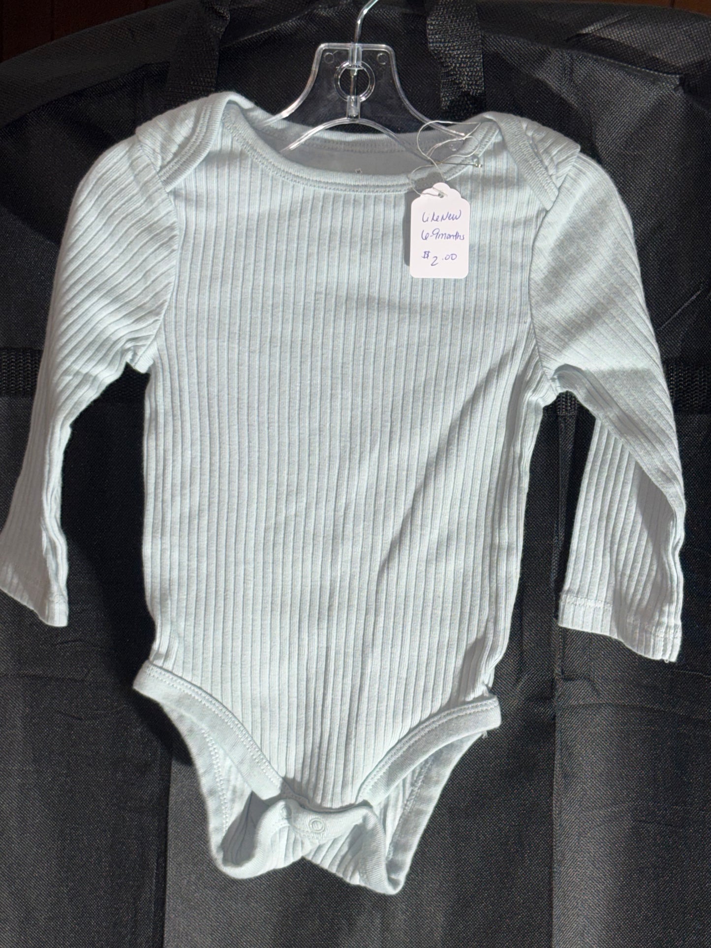 Size 6-9 month, cloud island brand, light blue long sleeve onesie