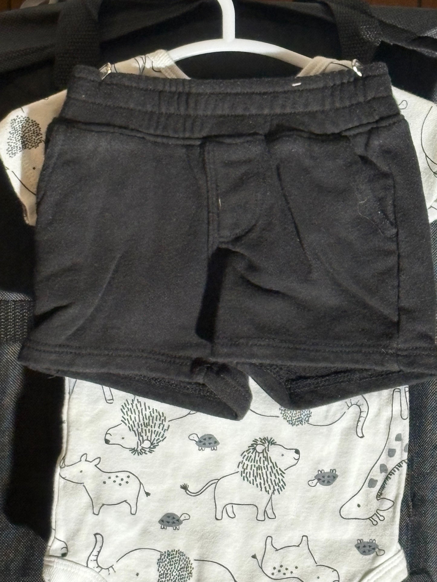 Size 3-6 month, Carters brand, white onesie with animal print and black shorts