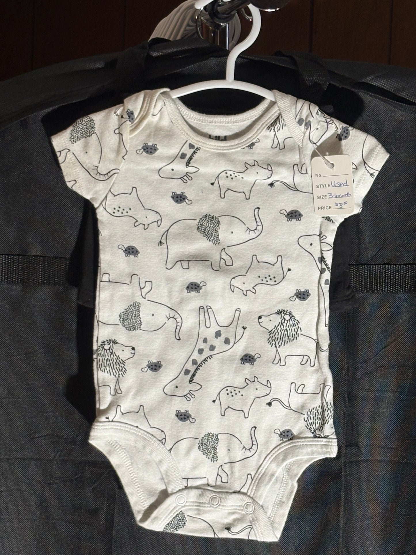 Size 3-6 month, Carters brand, white onesie with animal print and black shorts