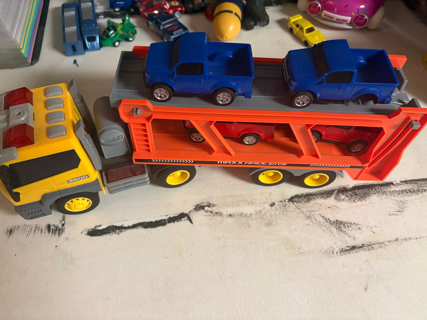 Truck with car trailer - 4 cars (one is missing a wheel)